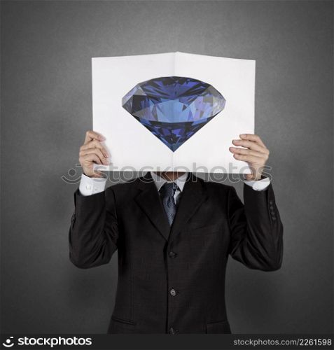 businessman hand show diamond cover book of success business as concept