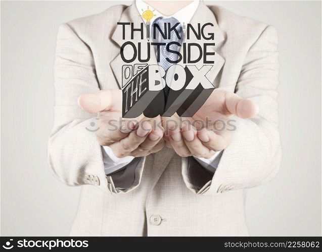 businessman hand showing design word THINKING OUTSIDE OF THE BOX as concept
