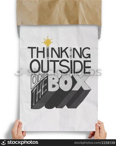 businessman hand showing design word THINKING OUTSIDE OF THE BOX on crumpled paper as concept