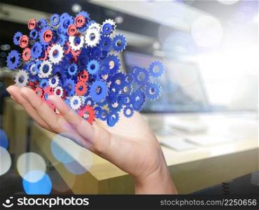 businessman hand showing gears cogs to success concept