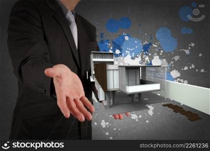 businessman hand shows house model and splash colors as concept