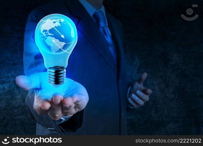 Businessman hand shows Light bulb with planet Earth social network as concept