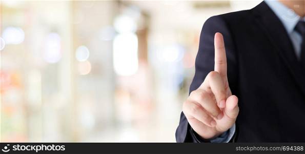 Businessman hand touching over blur office background, business background, banner