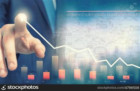 Businessman hand touching virtual graph on media screen. Business and finance