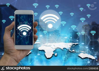 Businessman hand use smartphone with wifi icons connection and network communication on map world.