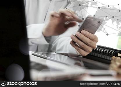 Businessman hand using blank screen laptop and mobile phone with social network diagram in office