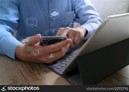 Businessman hand using mobile payments online shopping,omni channel,in modern office wooden desk,icons graphic interface screen
