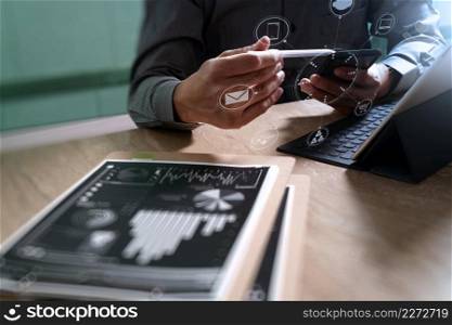 Businessman hand using mobile payments online shopping,omni channel,in modern office wooden desk,icons graphic interface screen