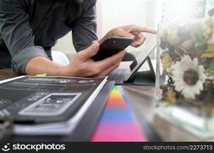 businessman hand using mobile payments online shopping,omni channel,laptop computer on wooden desk,glass vase flowers