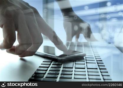 Businessman hand using mobile phone with social network diagram on wooden desk as concept
