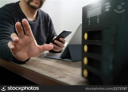 businessman hand using smart phone,mobile payments online shopping,omni channel,digital tablet docking keyboard computer,compact server on wooden desk