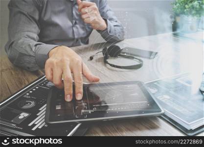Businessman hand using VOIP headset with digital tablet computer,document,concept communication,icon graph interface, call center and customer service help desk 