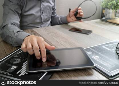 Businessman hand using VOIP headset with digital tablet computer,document,concept communication, it support, call center and customer service help desk
