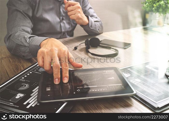 Businessman hand using VOIP headset with digital tablet computer,document,concept communication, it support, call center and customer service help desk,filter effect