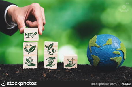 Businessman hand with paper globe and net zero symbol cube for eco awareness. Ethical company reduce CO2 emission, fight climate change and global warming by clean energy for green environment. Alter. Businessman hand with paper globe and wooden cube net zero symbol for eco. Alter