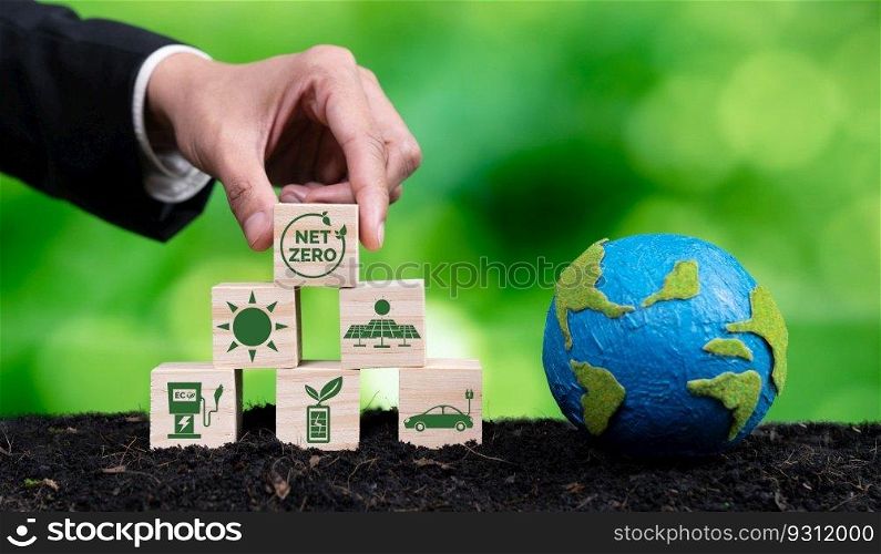 Businessman hand with paper globe and net zero symbol cube for eco awareness. Ethical company reduce CO2 emission, fight climate change and global warming by clean energy for green environment. Alter. Businessman hand with paper globe and wooden cube net zero symbol for eco. Alter