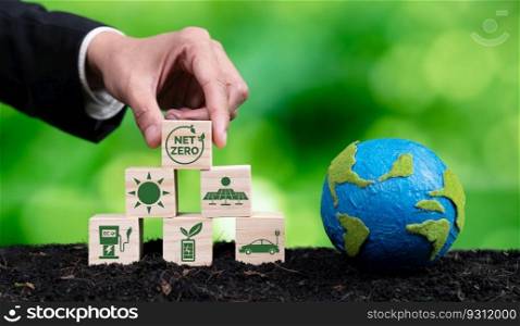 Businessman hand with paper globe and net zero symbol cube for eco awareness. Ethical company reduce CO2 emission, fight climate change and global warming by clean energy for green environment. Alter. Businessman hand with paper globe and wooden cube net zero symbol for eco. Alter