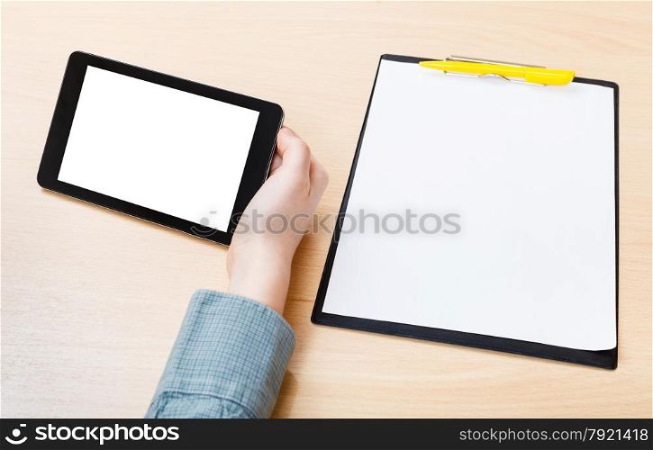 businessman hand with tablet PC with cut out screen at office table