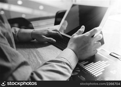 Businessman hand working concept. Documents finance graphic chart. Digital tablet keyboard dock screen computer design smart phone using. Sun flare effect, black white