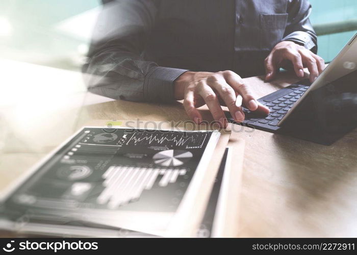 Businessman hand working concept. Documents finance graphic chart. Digital tablet keyboard dock screen computer design smart phone using. Eyeglass on marble desk. Sun flare effect