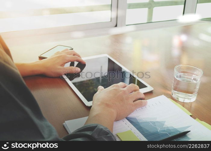 businessman hand working with blank screeen new modern computer laptop and pro digital tablet on wooden desk as concept