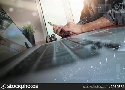 businessman hand working with new modern computer and business strategy documents digital layers with green plant foreground on wooden desk in office