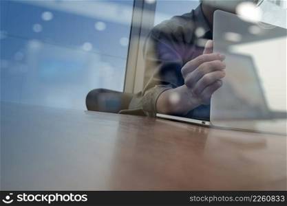 businessman hand working with new modern computer and smart phone and business strategy on wooden desk as concept