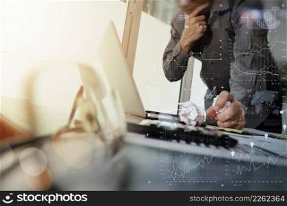 businessman hand working with new modern computer and smart phone and business strategy document with crumpled paper on wooden desk with calculator and eyeglass foreground as concept