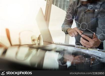 businessman hand working with new modern computer and smart phone and digital business strategy on wooden desk with calculator and eyeglass foreground as concept