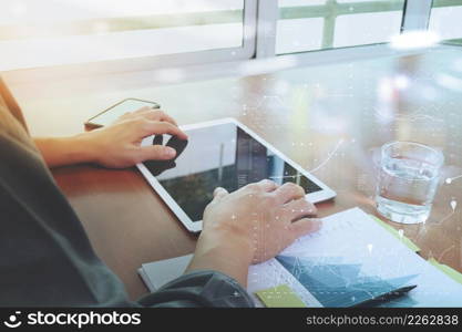 businessman hand working with new modern computer laptop and pro digital tablet with digital business diagram on wooden desk as concept