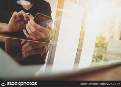 businessman hand working with new tablet modern computer and smart phone on wooden desk