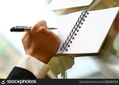 businessman hand write message in note