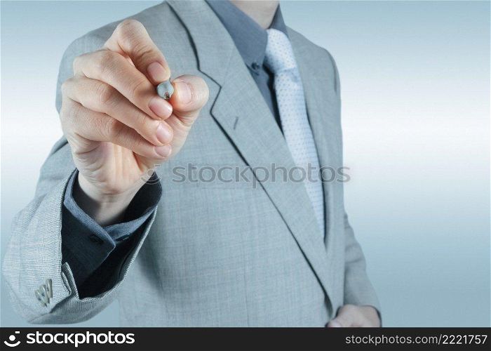 businessman hand writing in the whiteboard or virtual screen