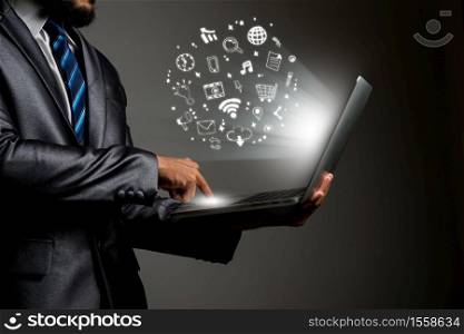 Businessman hands using laptop with doodle business icons. Communication concept.