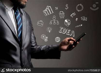 Businessman hands using smartphone with doodle business icons. Communication concept.