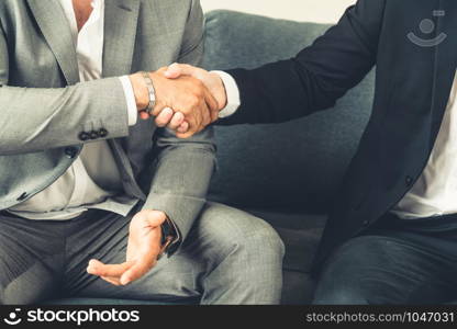 Businessman handshake with another businessman partner in modern workplace office. People corporate business deals concept.