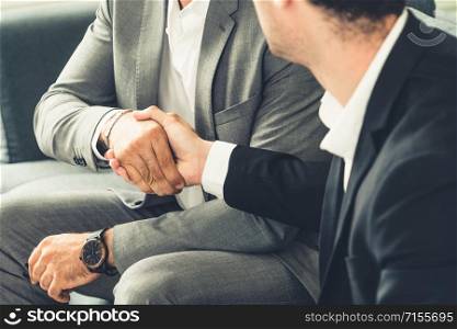 Businessman handshake with another businessman partner in modern workplace office. People corporate business deals concept.