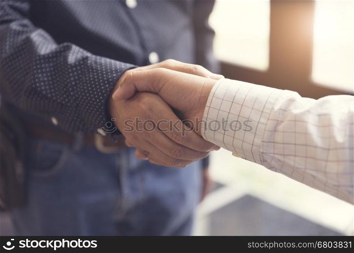 businessman handshaking for business cooperation and acquisiton concept, selective focus and vintage tone
