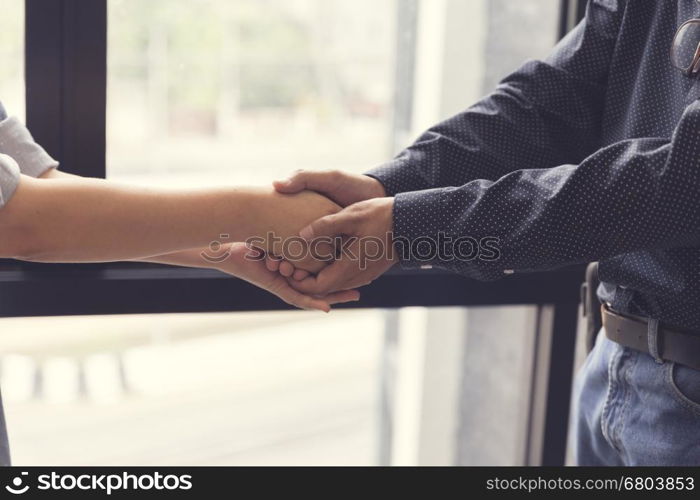 businessman handshaking for business cooperation and acquisiton concept, selective focus and vintage tone