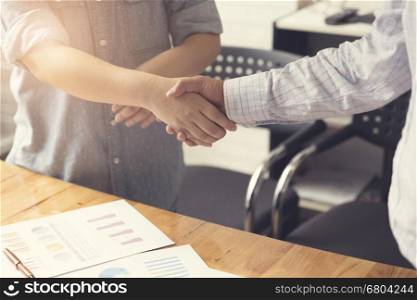 businessman handshaking for business cooperation and acquisiton concept, selective focus and vintage tone