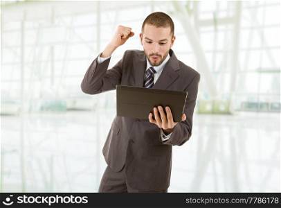 businessman happy using touch pad of tablet pc, at the office