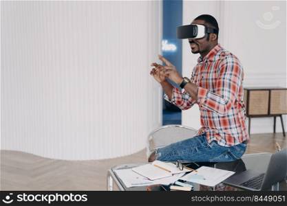 Businessman has virtual course. African american man in vr glasses at home. Virtual reality headset using, electronic device. Modern education and digital technology for business and creativity.. Businessman has virtual course. African american man is using vr glasses at home.