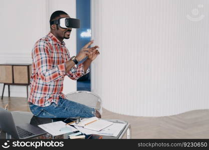 Businessman has virtual course. African american man in vr glasses at home. Virtual reality headset using, electronic device. Modern education and digital technology for business and creativity.. Businessman has virtual course. African american man is using vr glasses at home.