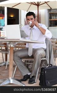 Businessman having a coffee break on a terrace