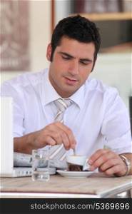 Businessman having an expresso in a cafe