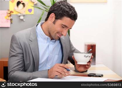 Businessman having coffee before work