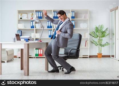 Businessman having fun taking a break in the office at work