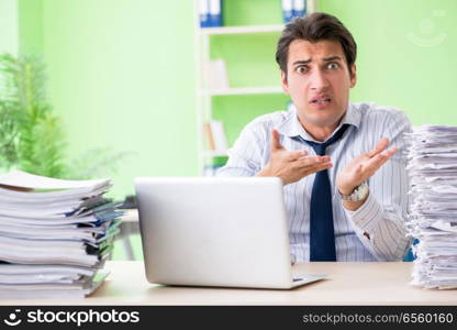 Businessman having problems with paperwork and workload