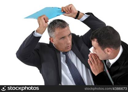 Businessman hitting a colleague