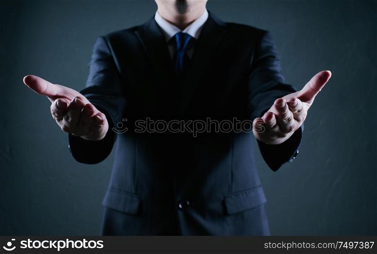 Businessman hold gesture pose . Low key lighting .